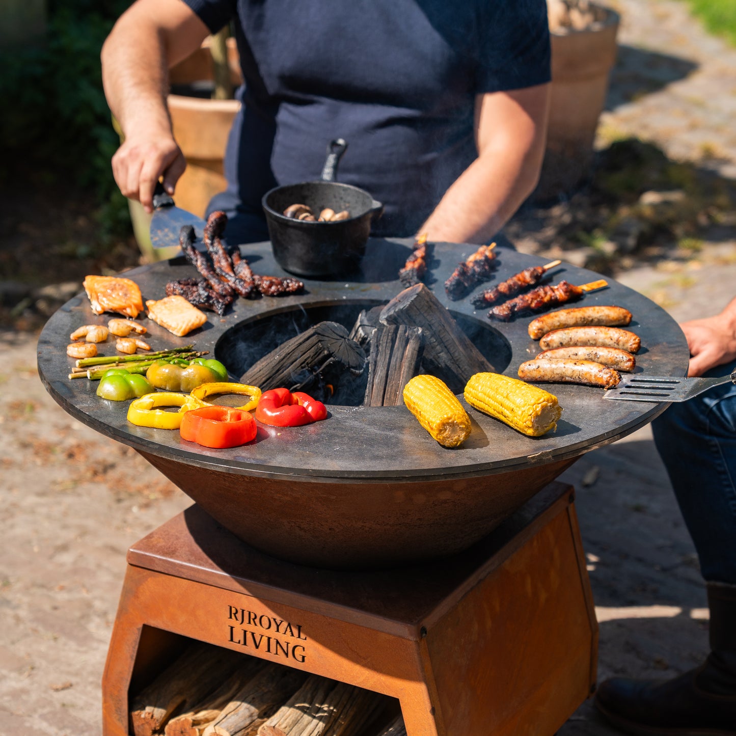 BBQ Plancha Grill Brasero Corten steel fire bowl with large wheels, wood storage and Cooking Plate Ø80cm