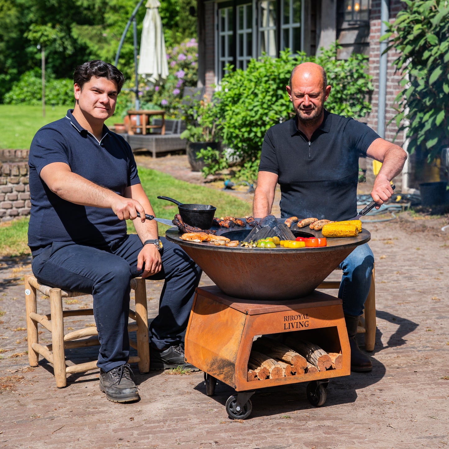 BBQ Plancha Grill Brasero Corten steel fire bowl with large wheels, wood storage and Cooking Plate Ø80cm