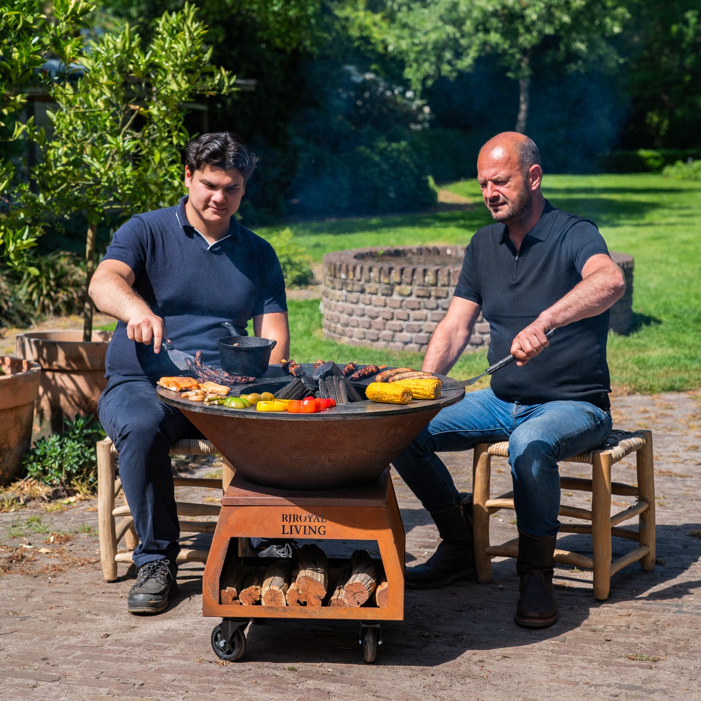 BBQ Plancha Grill Brasero Corten steel fire bowl with large wheels, wood storage and Cooking Plate Ø80cm