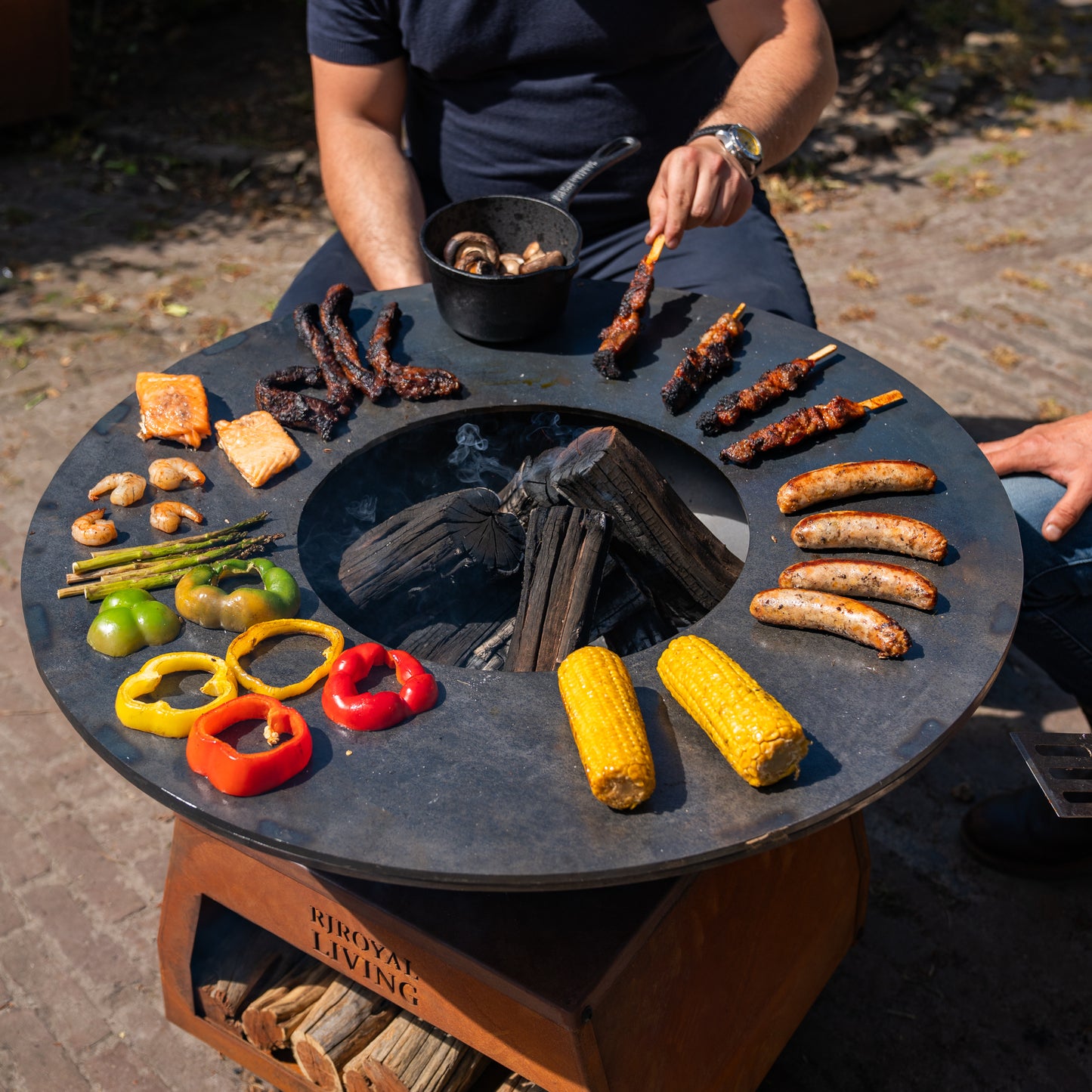 BBQ Plancha Grill Brasero Corten steel fire bowl with large wheels, wood storage and Cooking Plate Ø80cm