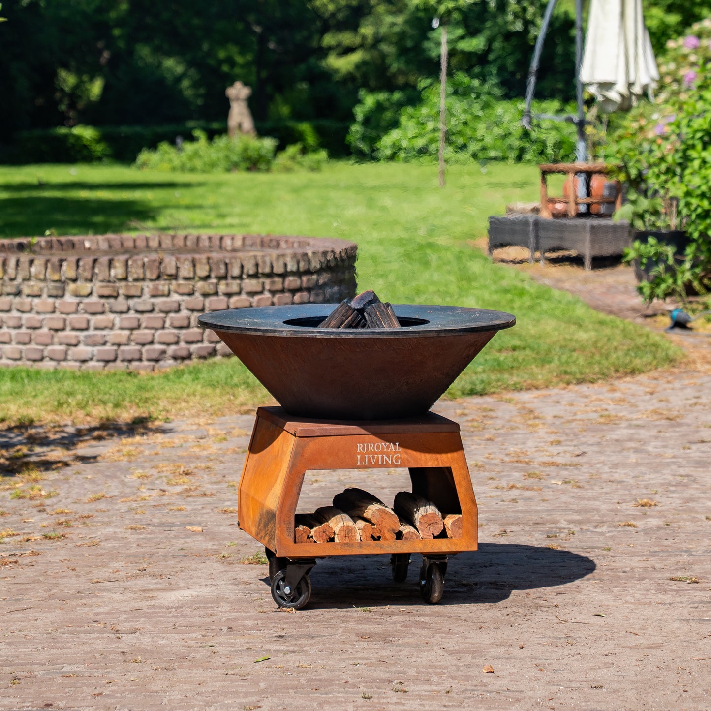 BBQ Plancha Grill Brasero Corten steel fire bowl with large wheels, wood storage and Cooking Plate Ø80cm