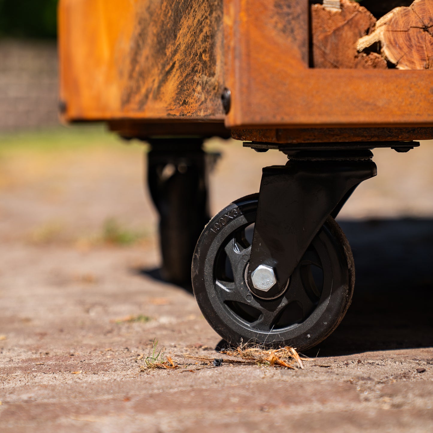 BBQ Plancha Grill Brasero Corten steel fire pit with large wheels and wood storage Ø75cm