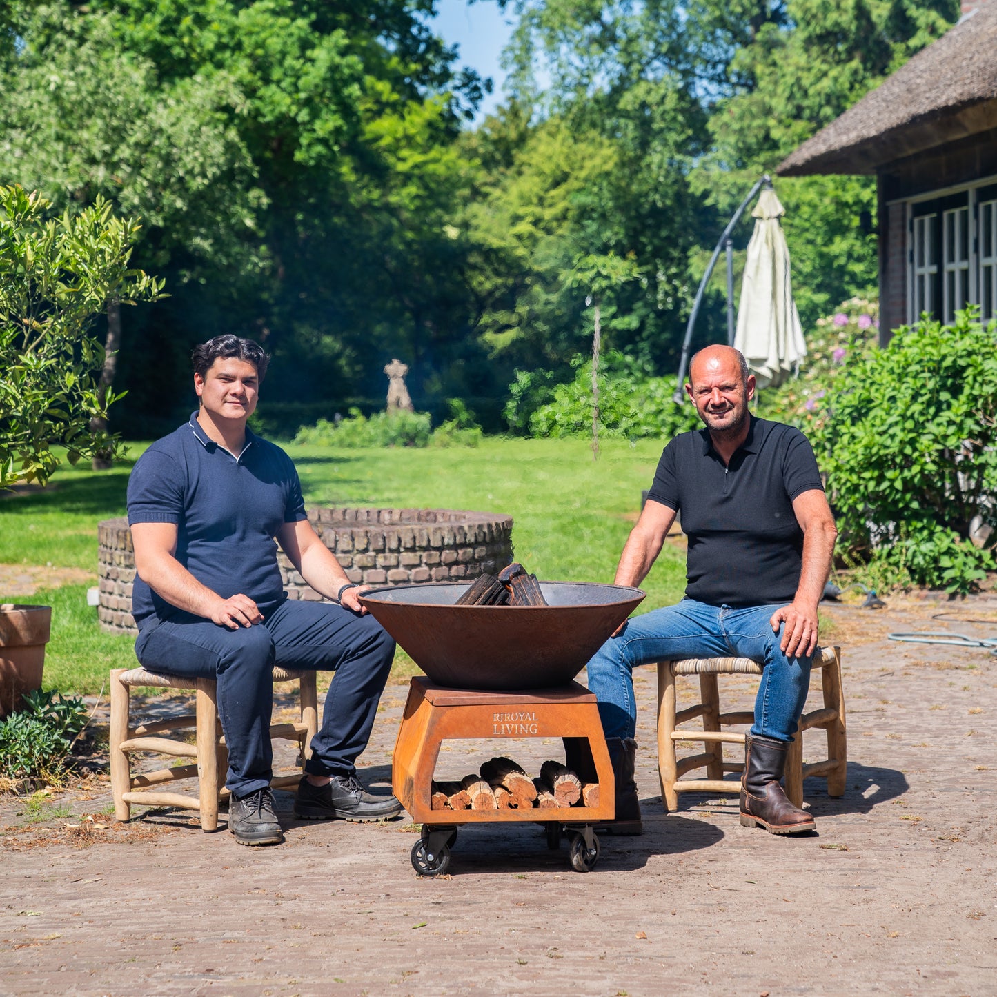 BBQ Plancha Grill Brasero Corten steel fire pit with large wheels and wood storage Ø75cm